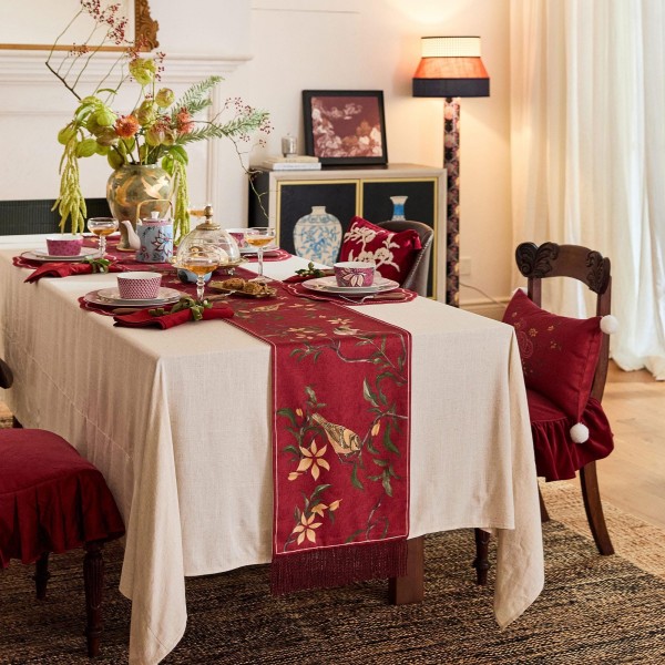 Red table runner with bird and flower pattern