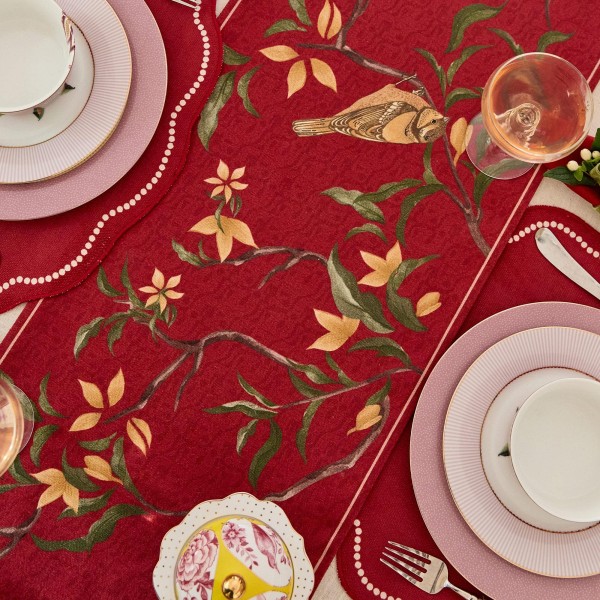 Red table runner with bird and flower pattern