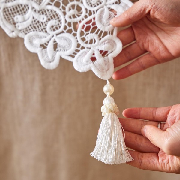 White cotton lace table runner with cutout details