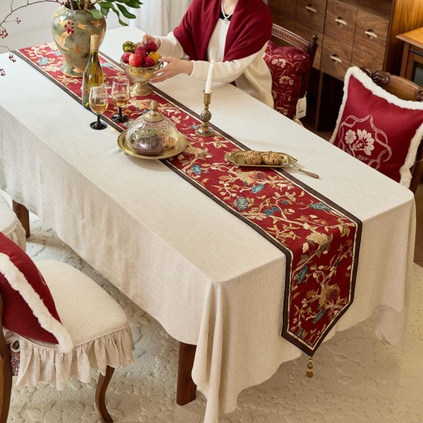 Red table runner with gold floral pattern