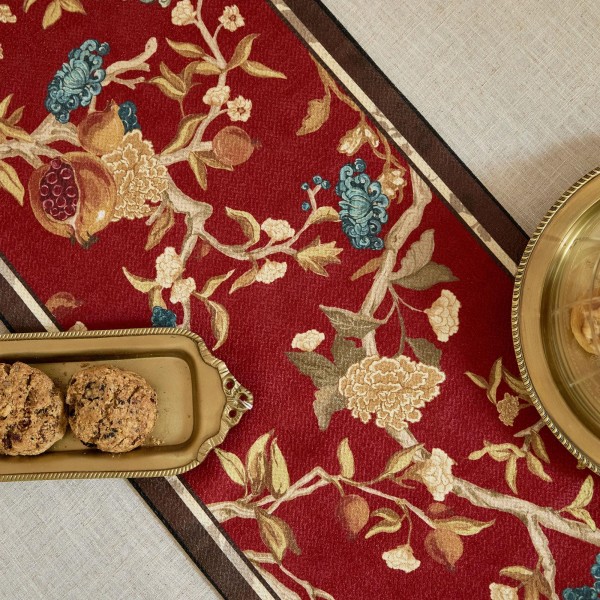 Red table runner with gold floral pattern