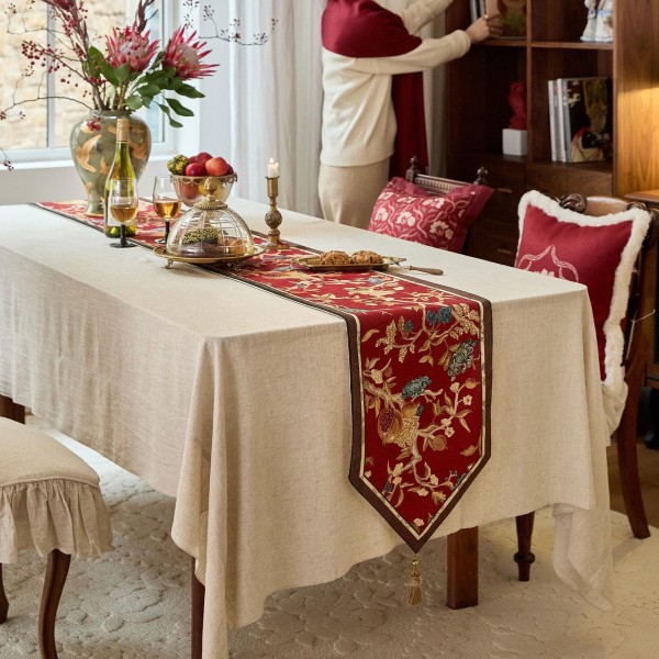 Red table runner with gold floral pattern