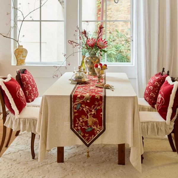Red table runner with gold floral pattern
