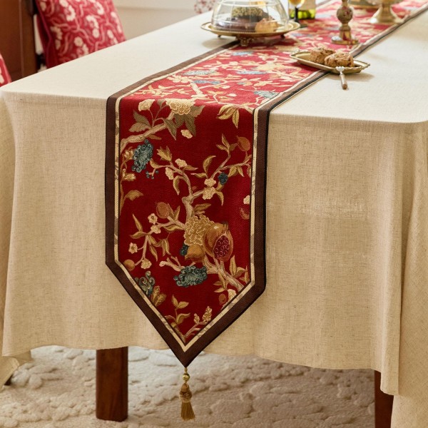 Red table runner with gold floral pattern